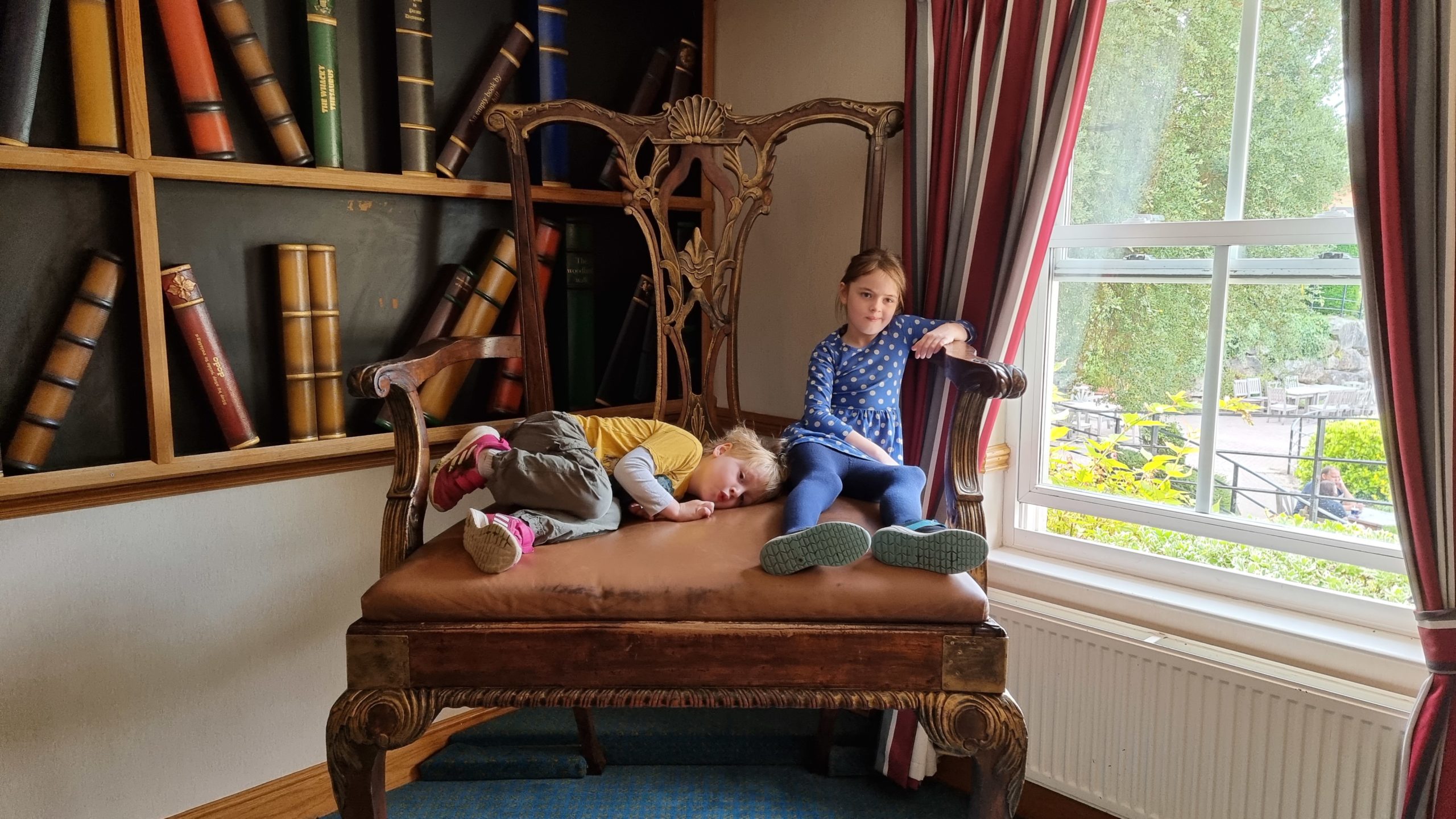 Full image of The kids on an enormous chair.