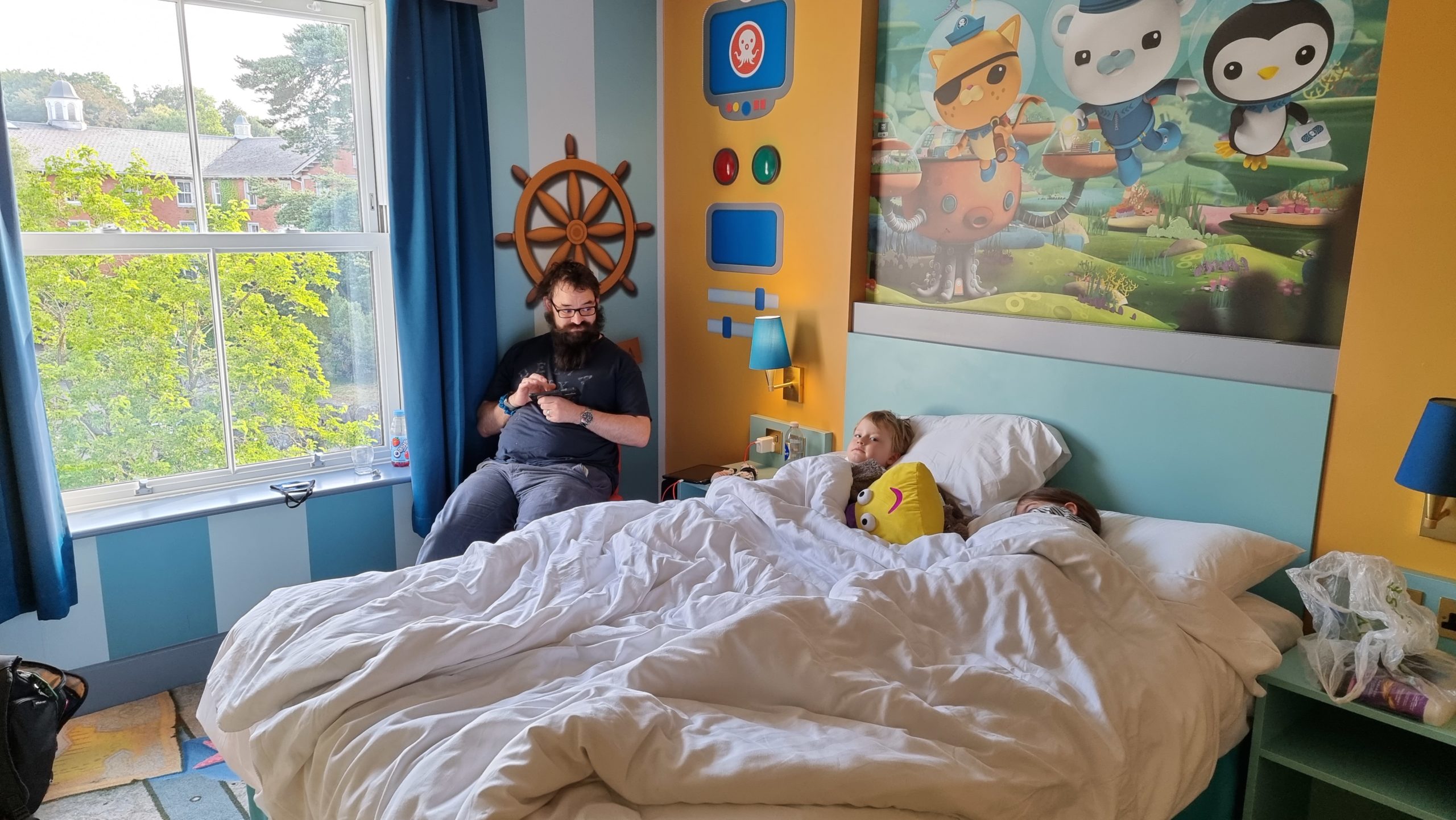 Full image of JTA and the kids relaxing in our Octonauts-themed hotel room.