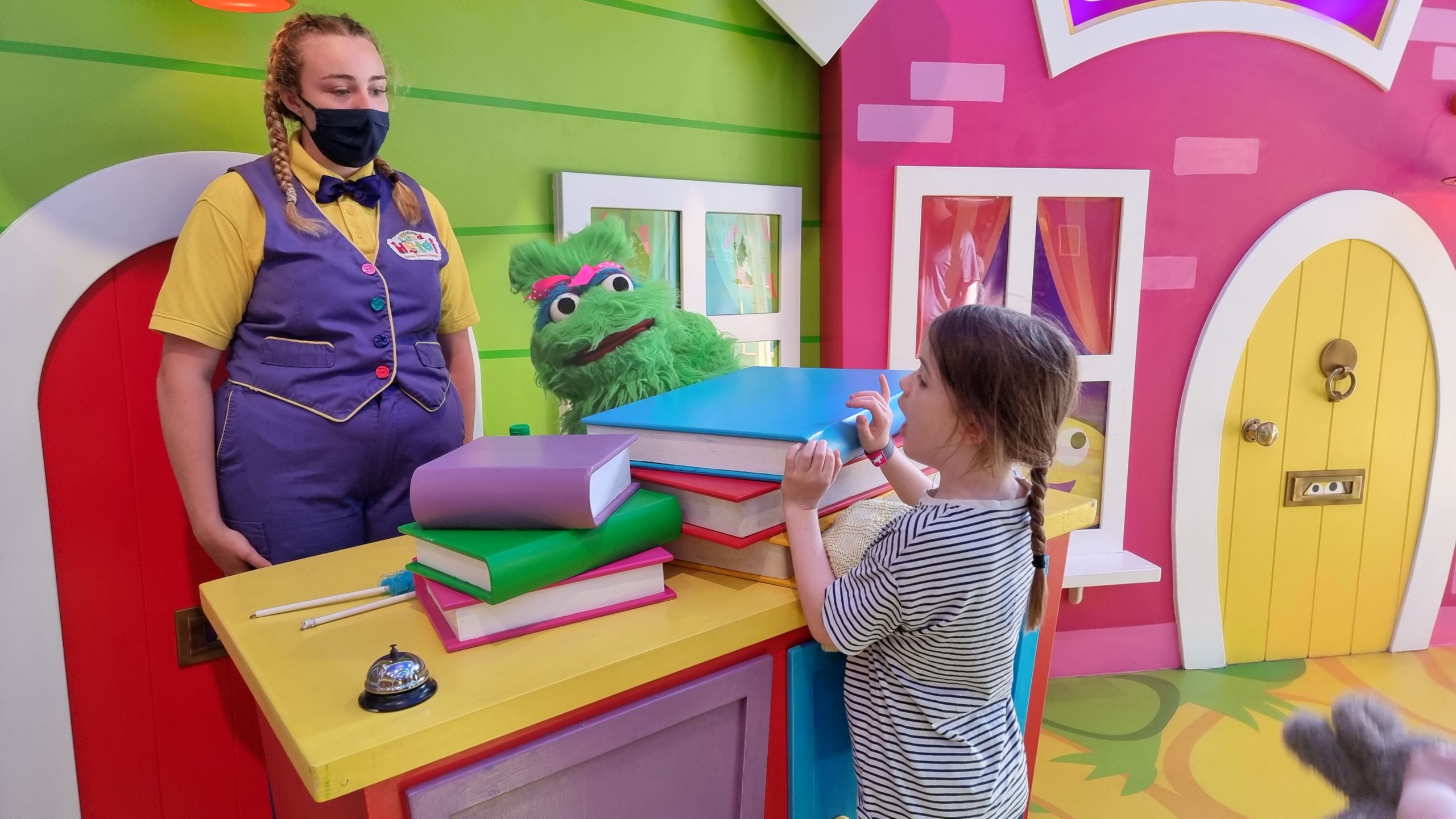 Full image of A muppet assists with hotel checkin.