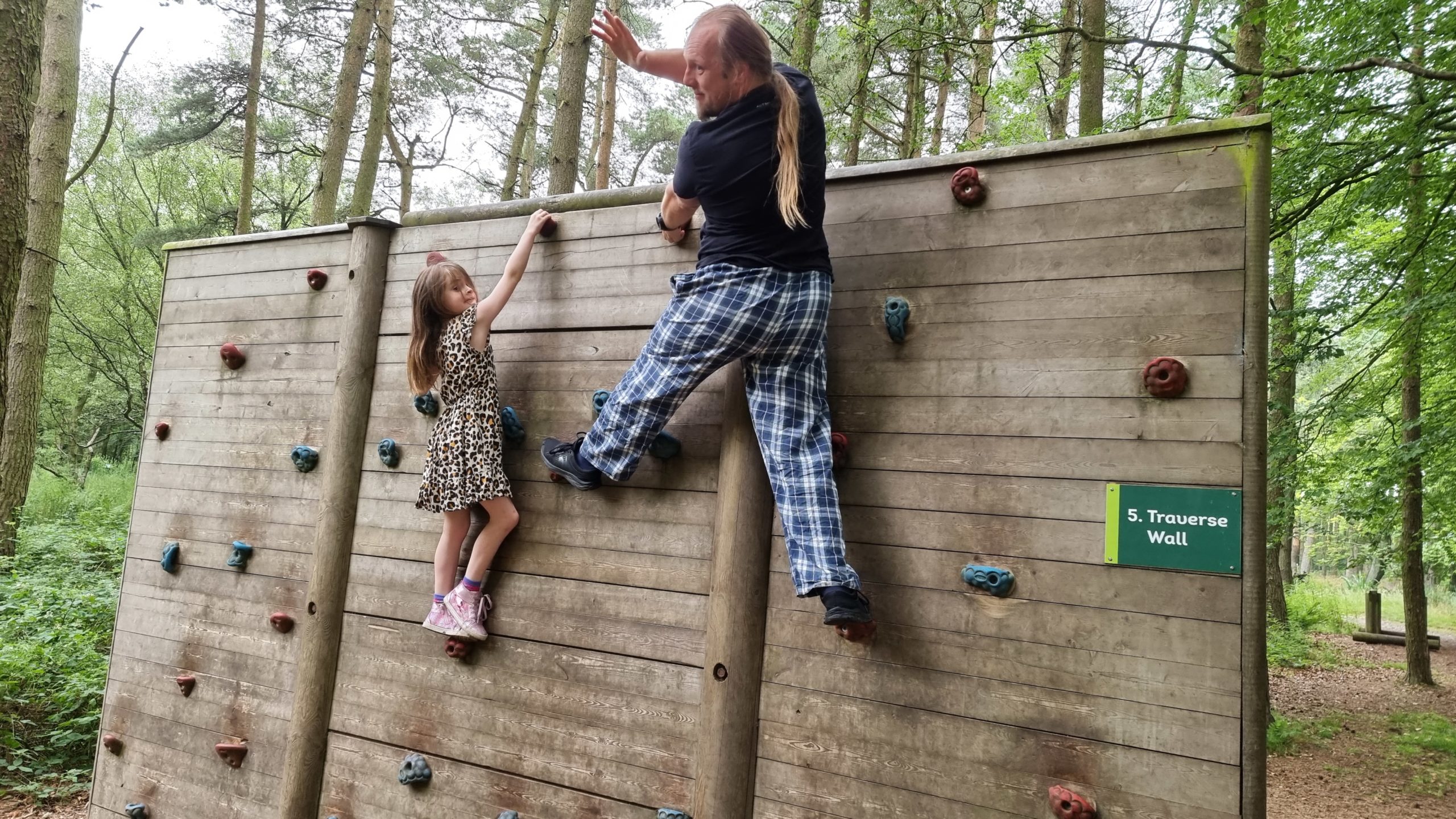 Full image of Dan on a climbing wall.