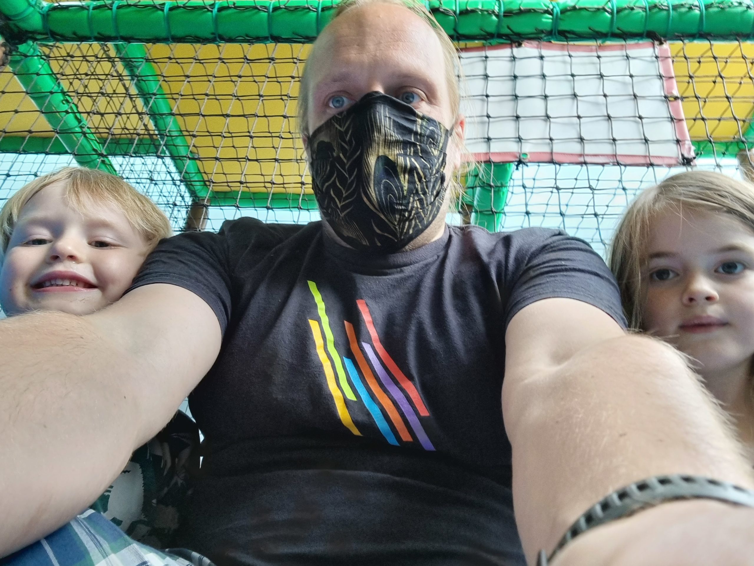 Full image of Dan and the kids on a racing slide.