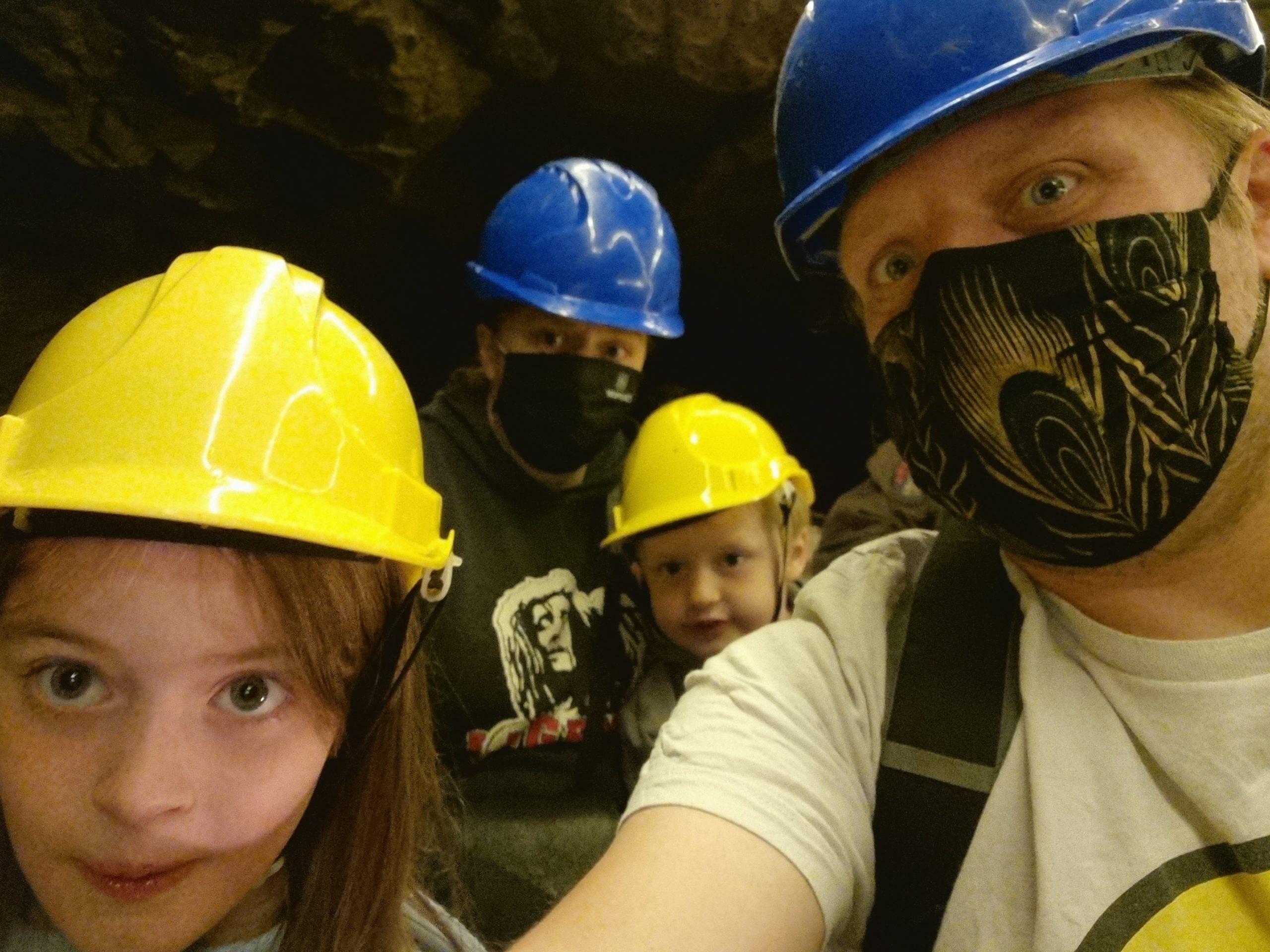 Full image of Dan, Ruth and the kids in a boat down a cave.