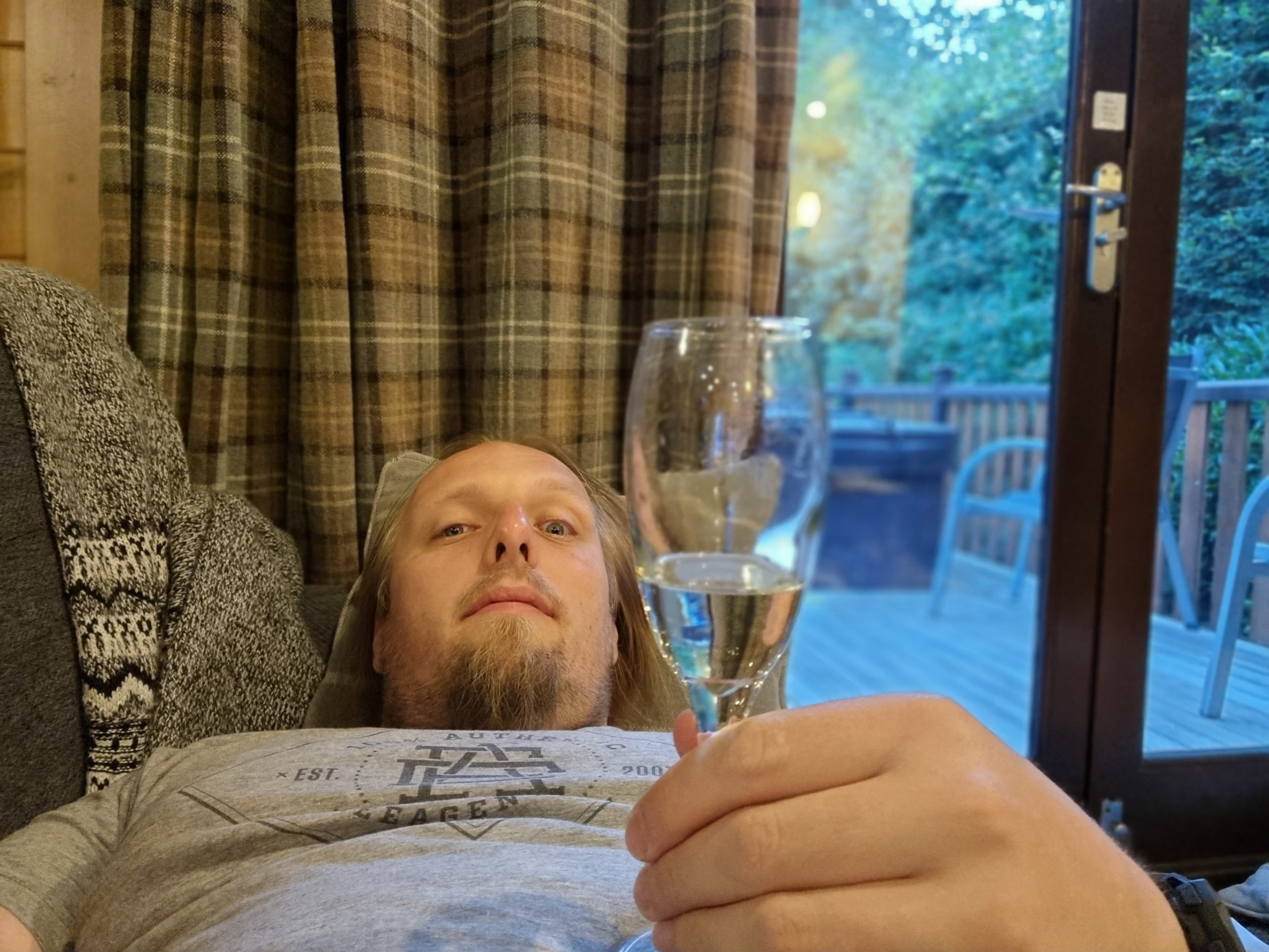 Full image of Dan drinking from a champagne flute.