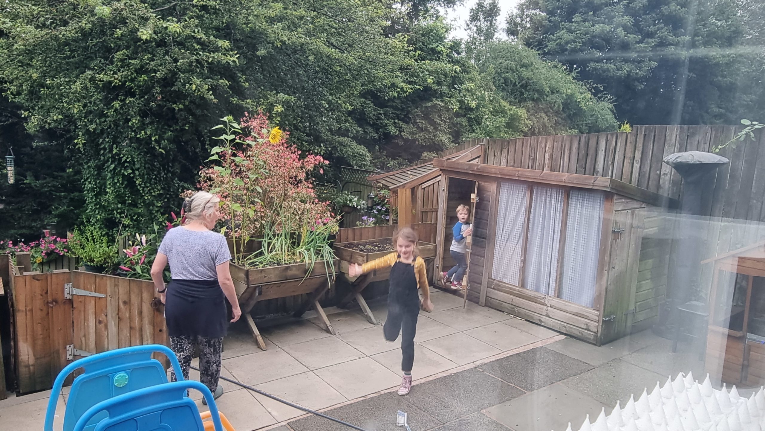 Full image of Children running out of a shed.