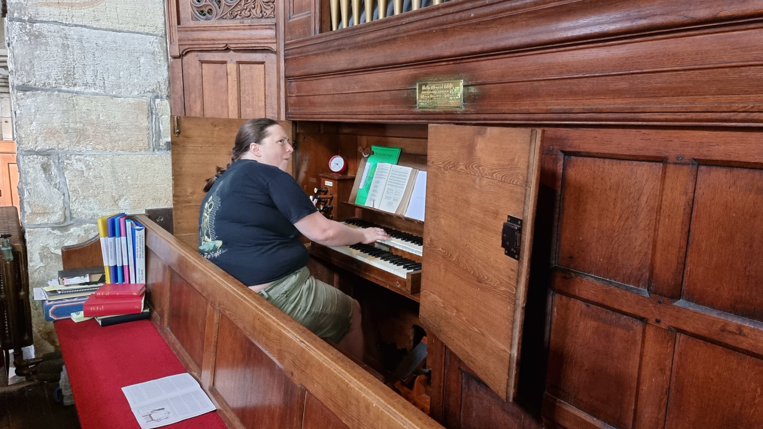 Full image of Ruth plays a pipe organ.