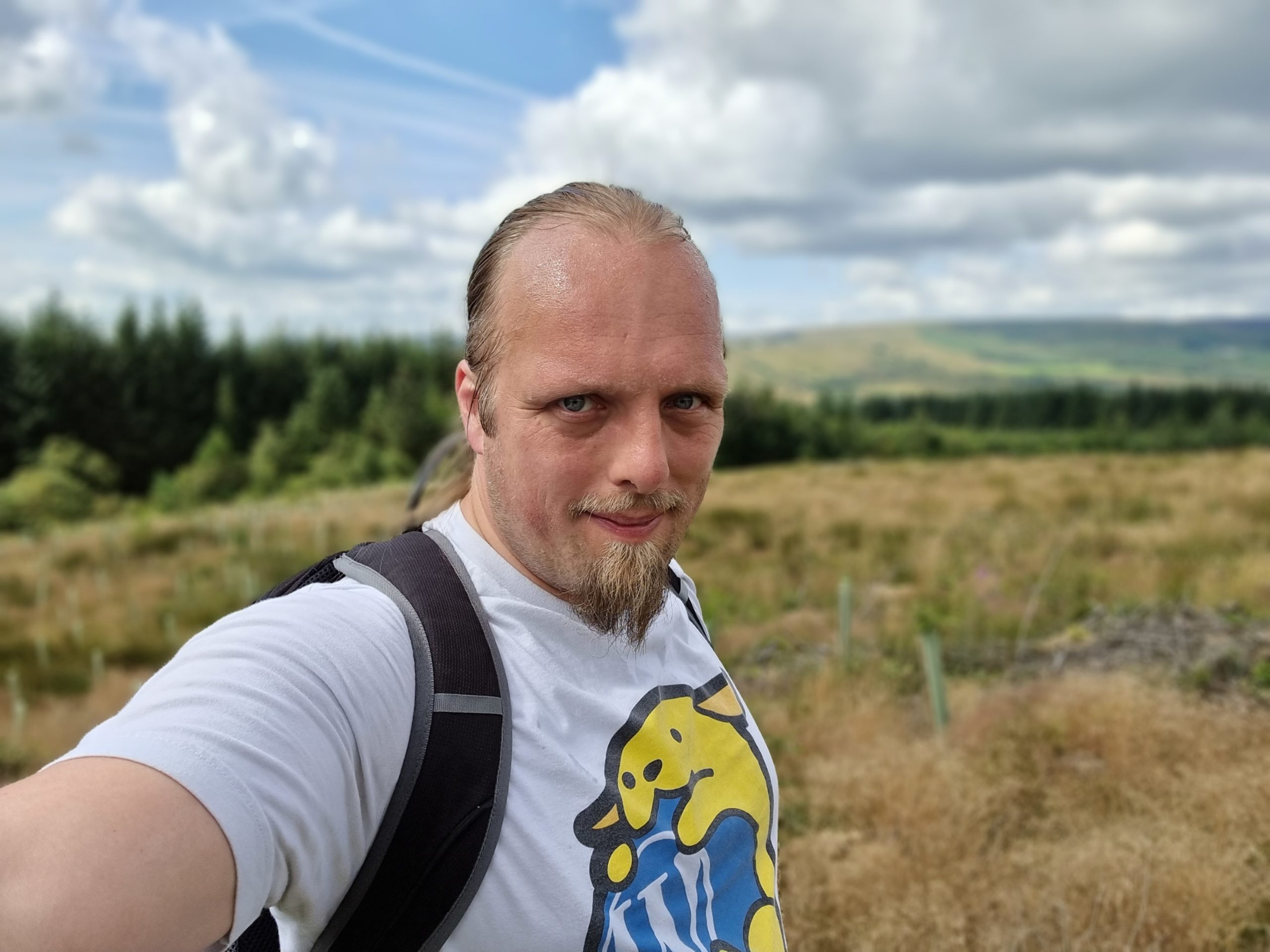 Full image of Dan, sweaty, at the top of a rise.