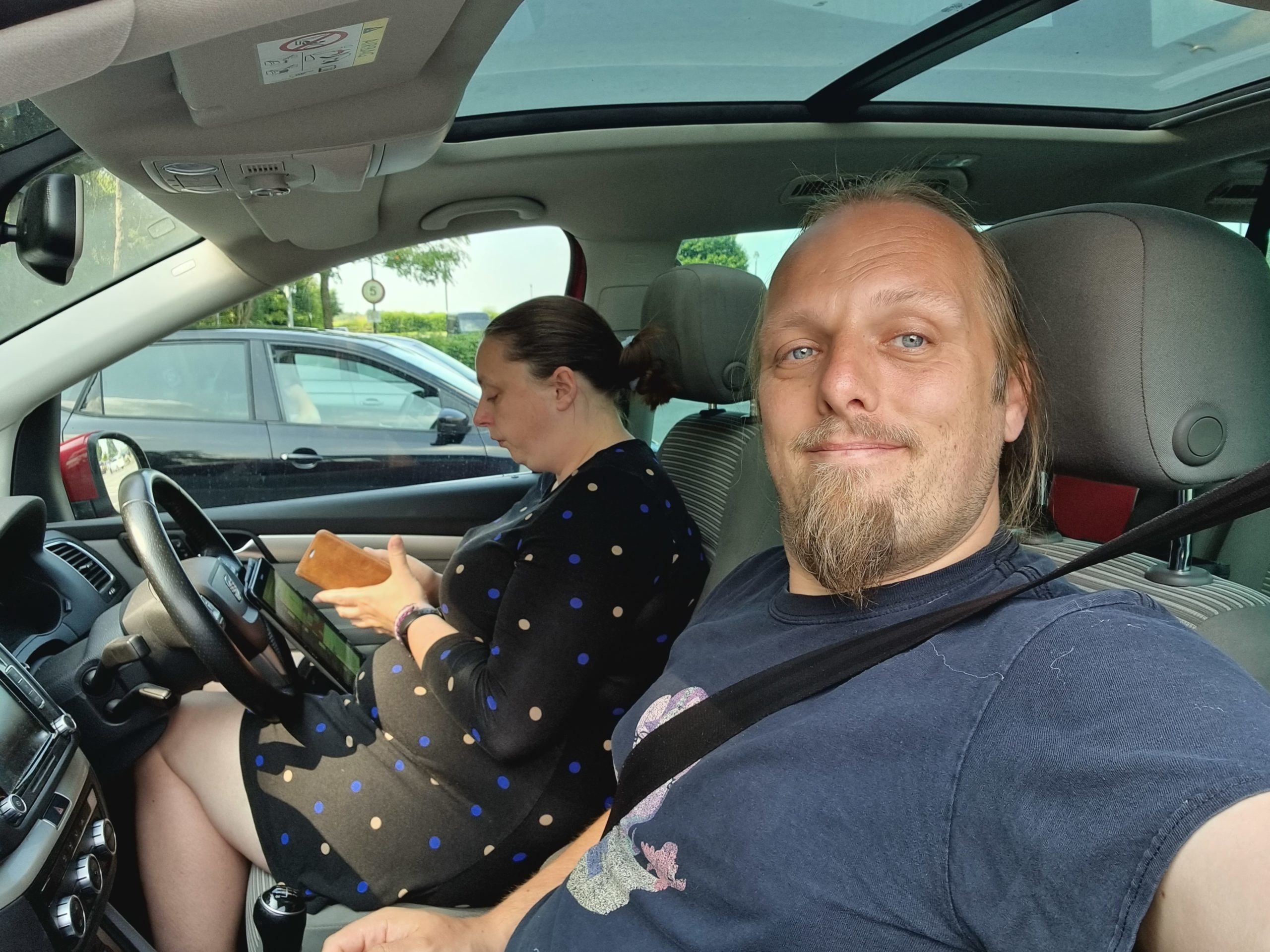 Full image of Ruth and Dan in a car, in a car park.