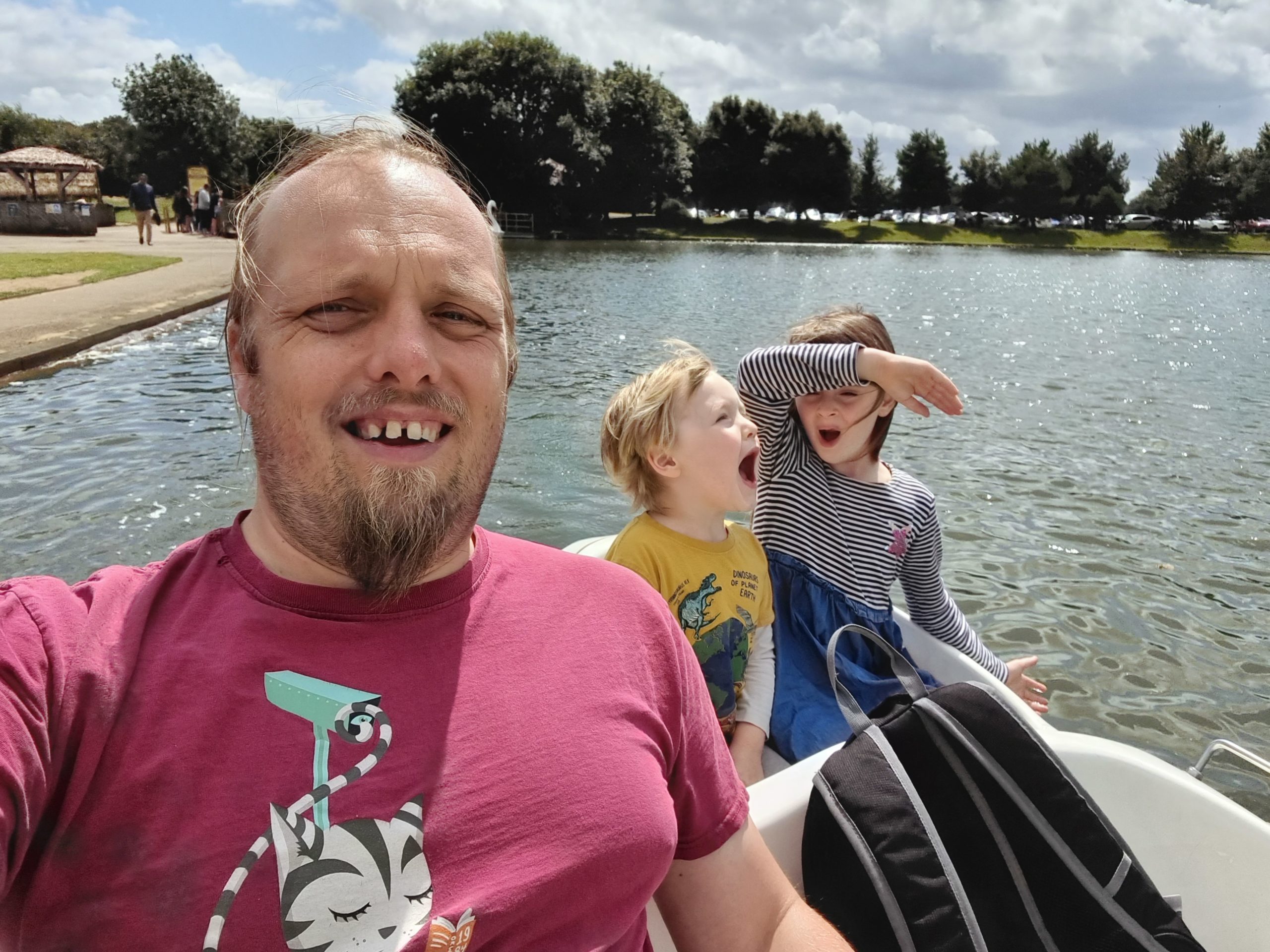 Full image of Dan and the kids on a swan boat.