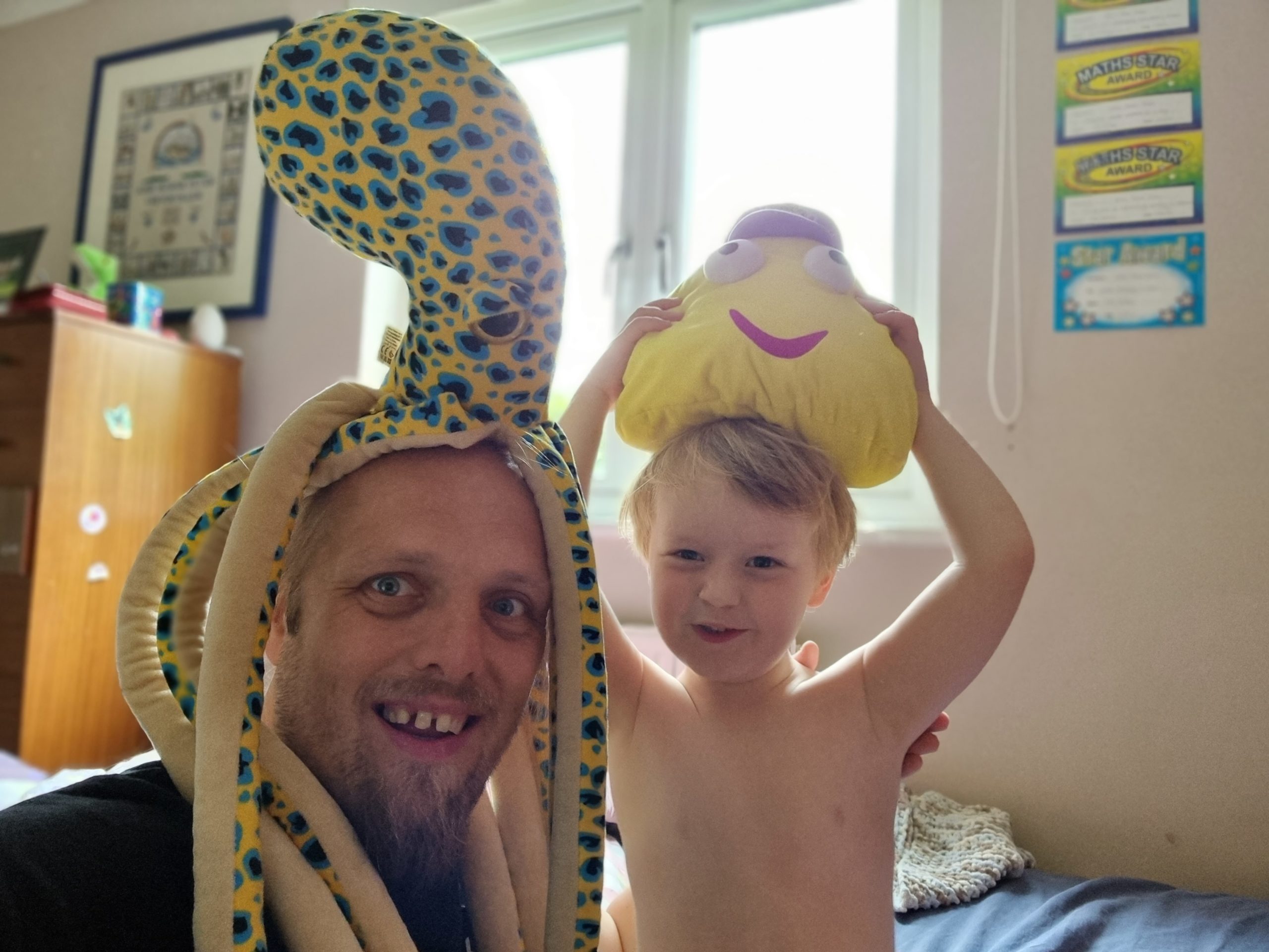 Full image of Dan and his 4-year-old wearing silly hats.