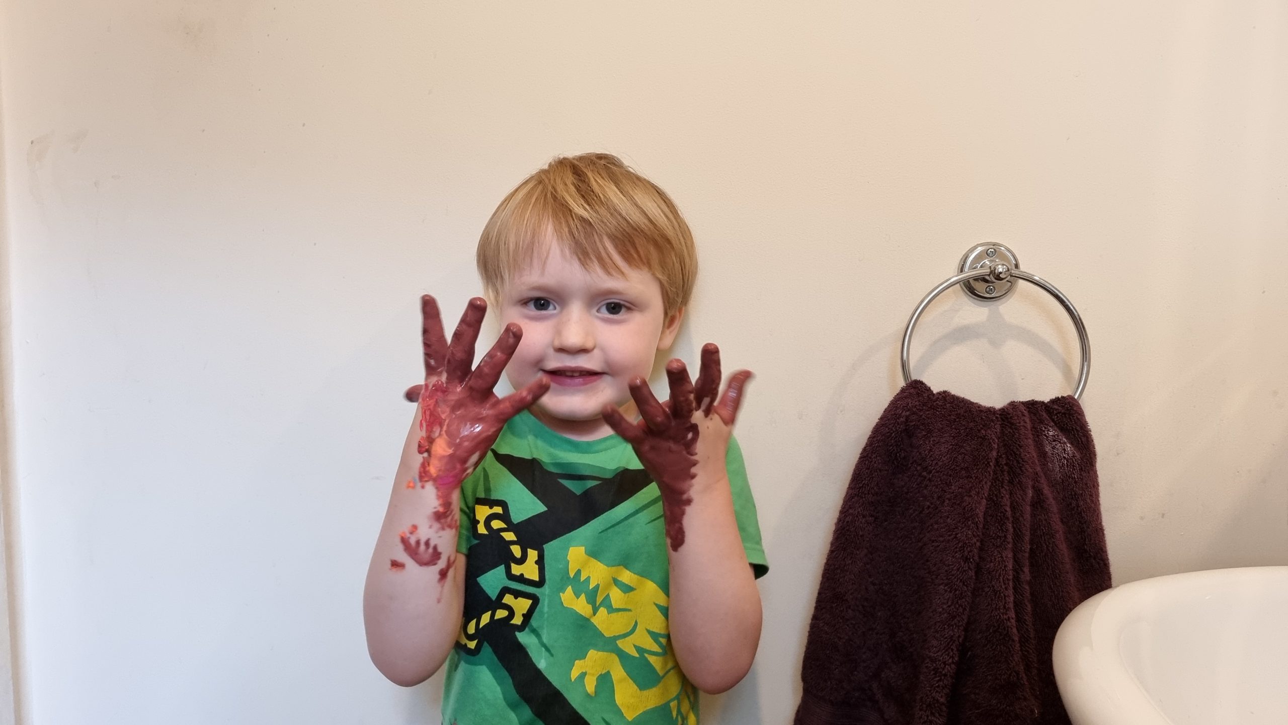 Full image of Boy with painted brown hands.