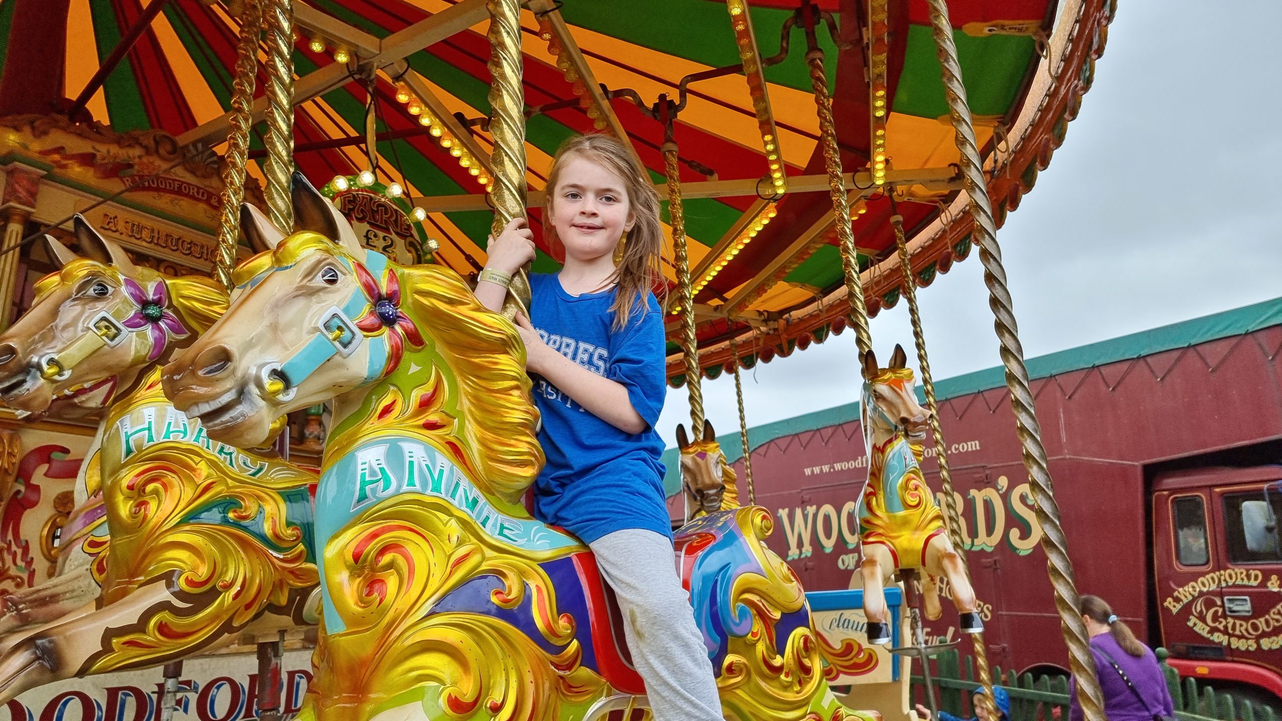 Full image of A girl on a carousel horse called "Annie".