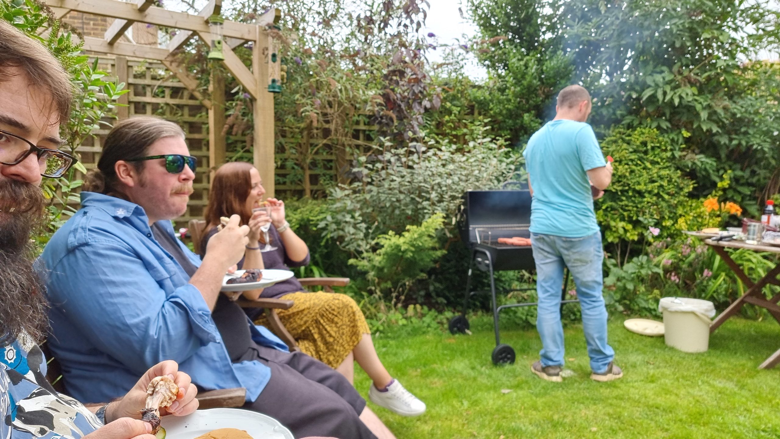 Full image of Adults eat barbecue food.
