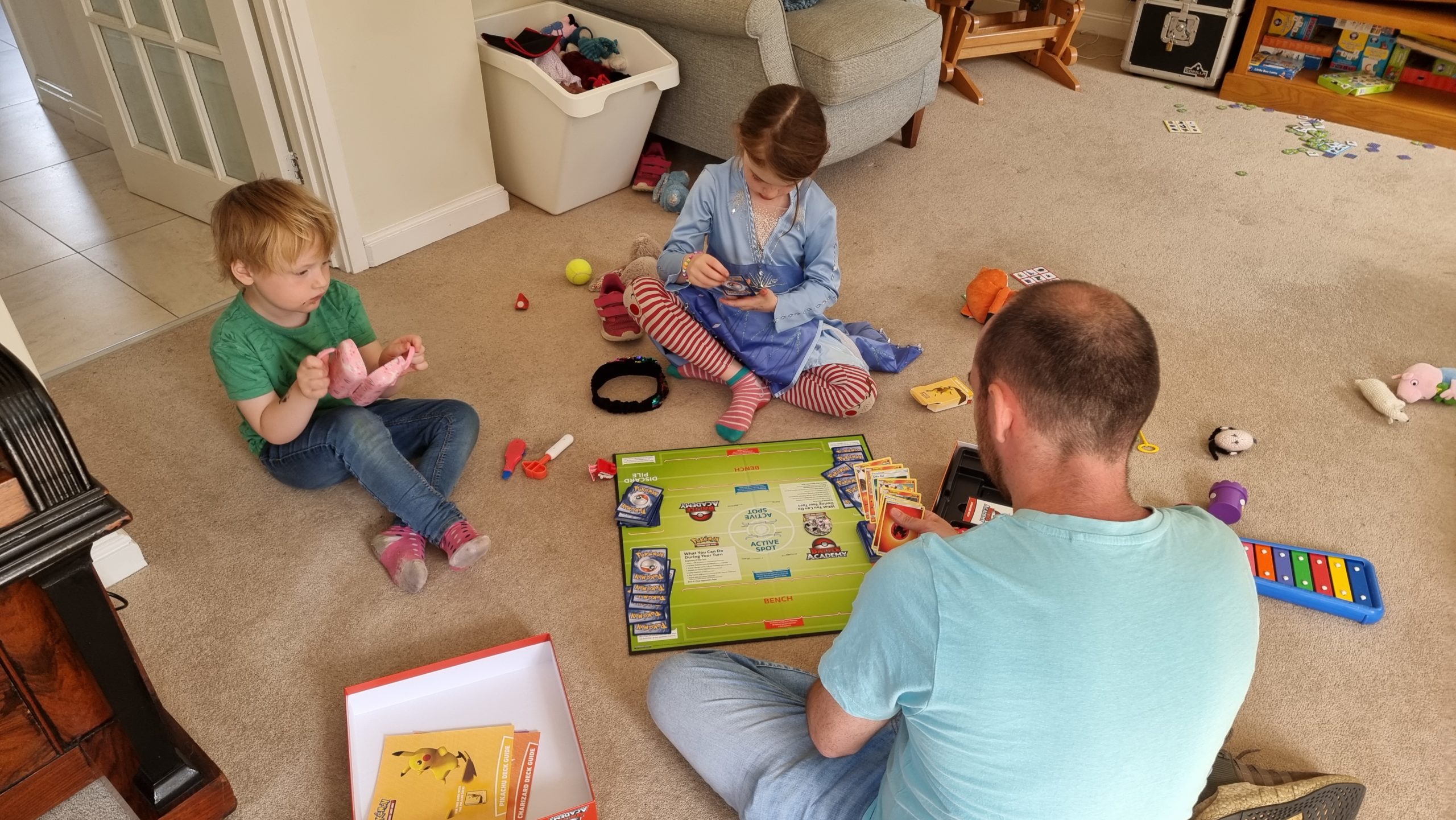 Full image of Children watch as our 7-year-old plays Pokemon with Simon.