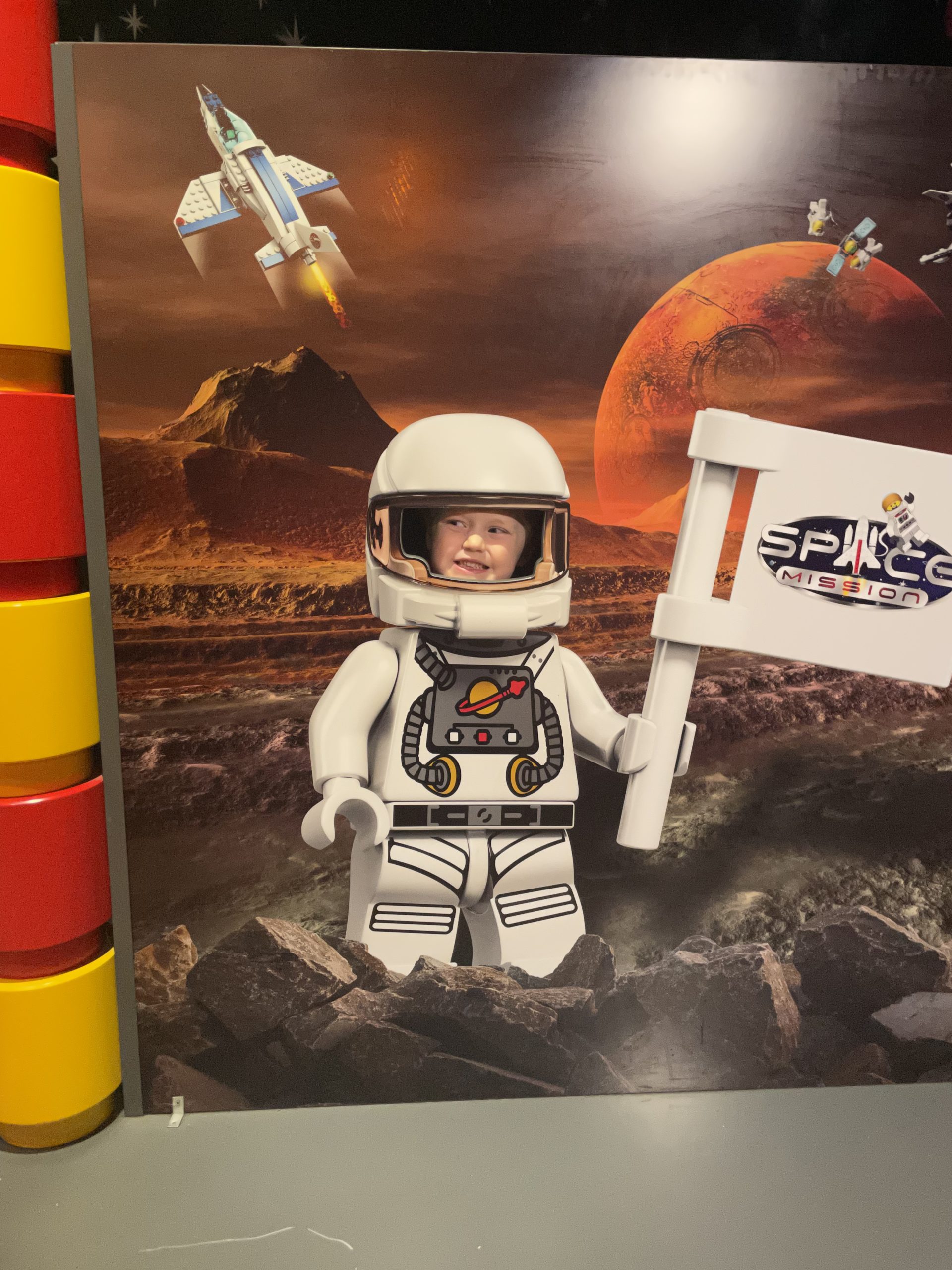 Full image of Child in a lego space suit.