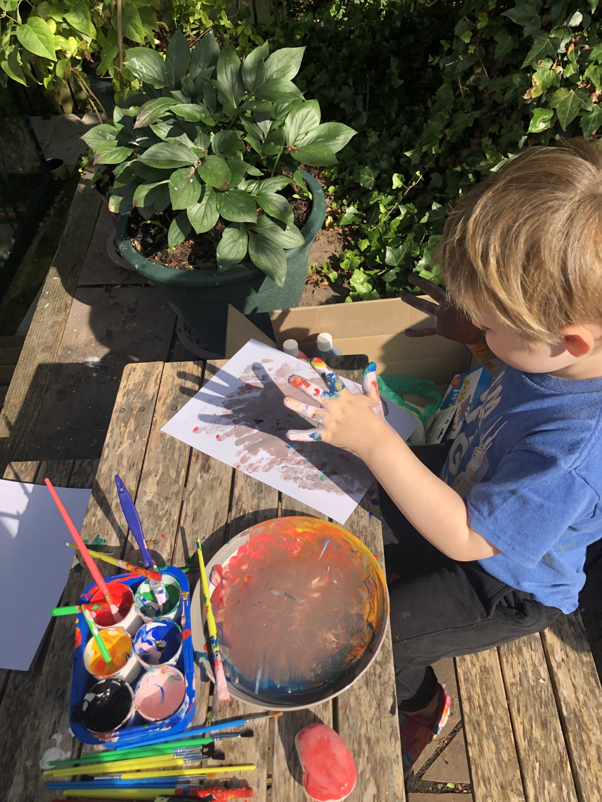 Full image of A boy doing finger painting.
