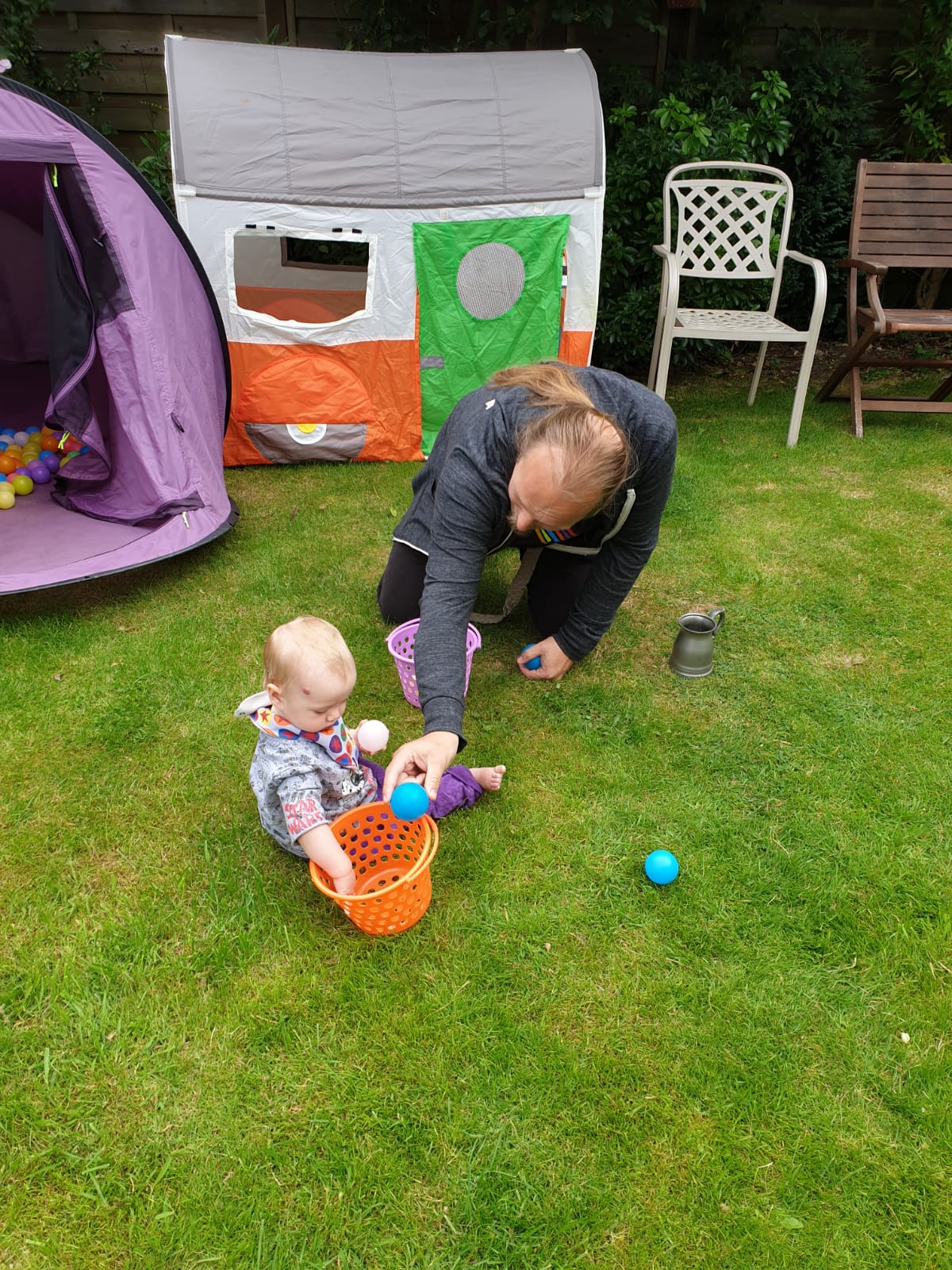 Full image of Dan plays with a small baby.
