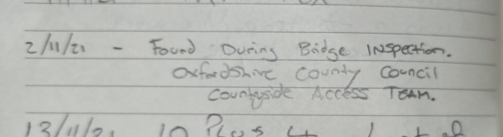 Geocache logbook entry reading: "2/11/21 - Found during bridge inspection. Oxfordshire County Council Countryside Access Team."
