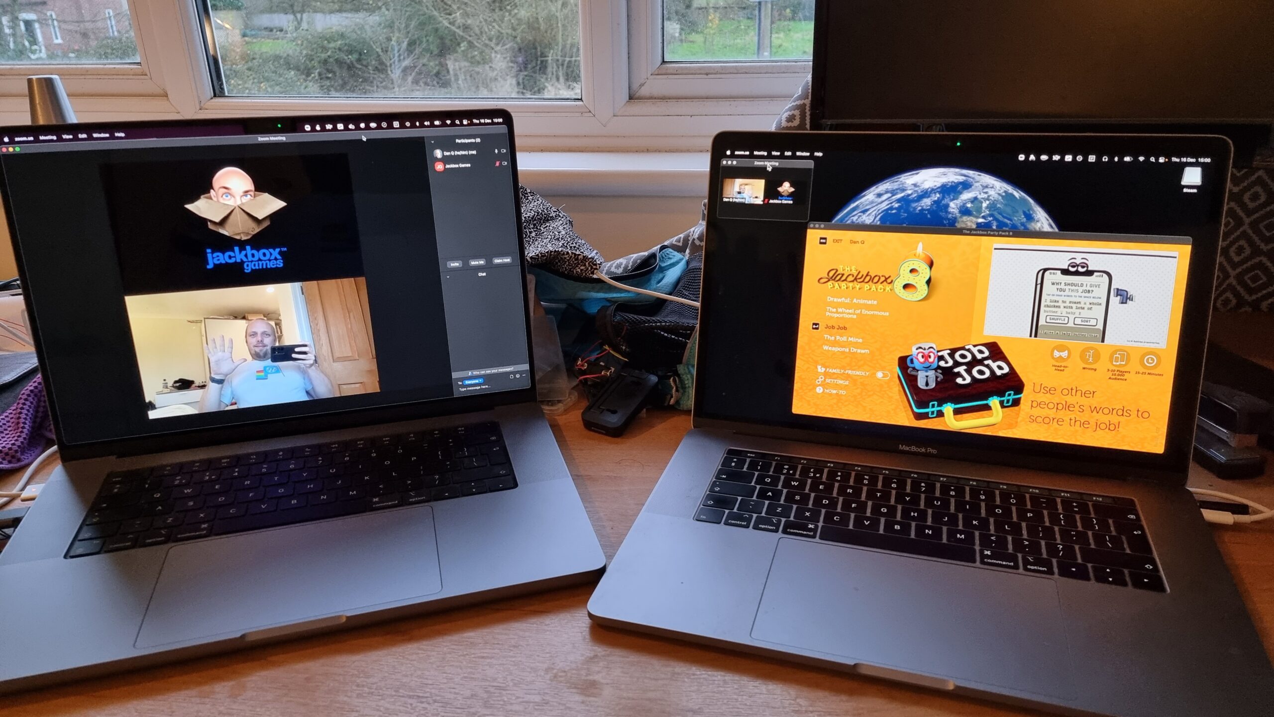 Full image of Two laptops: one showing a full-screen Zoom chat with Dan and "Jackbox Games"; the second showing a windowed copy of Jackbox Party Pack 8.