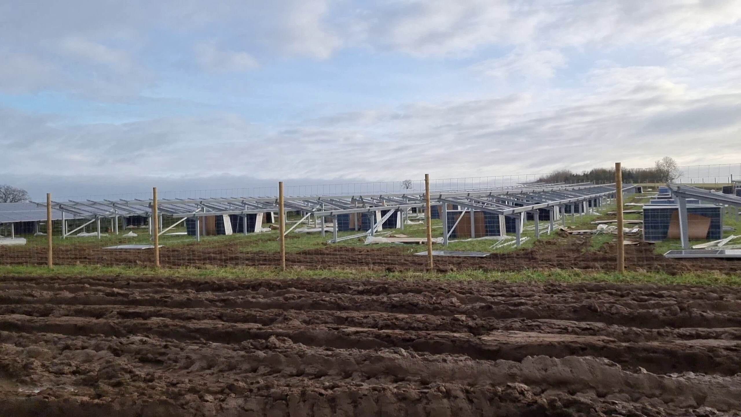 Full image of Solar panels under construction in a field