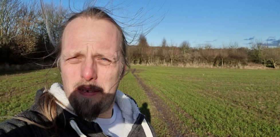 Dan, windswept, in a field