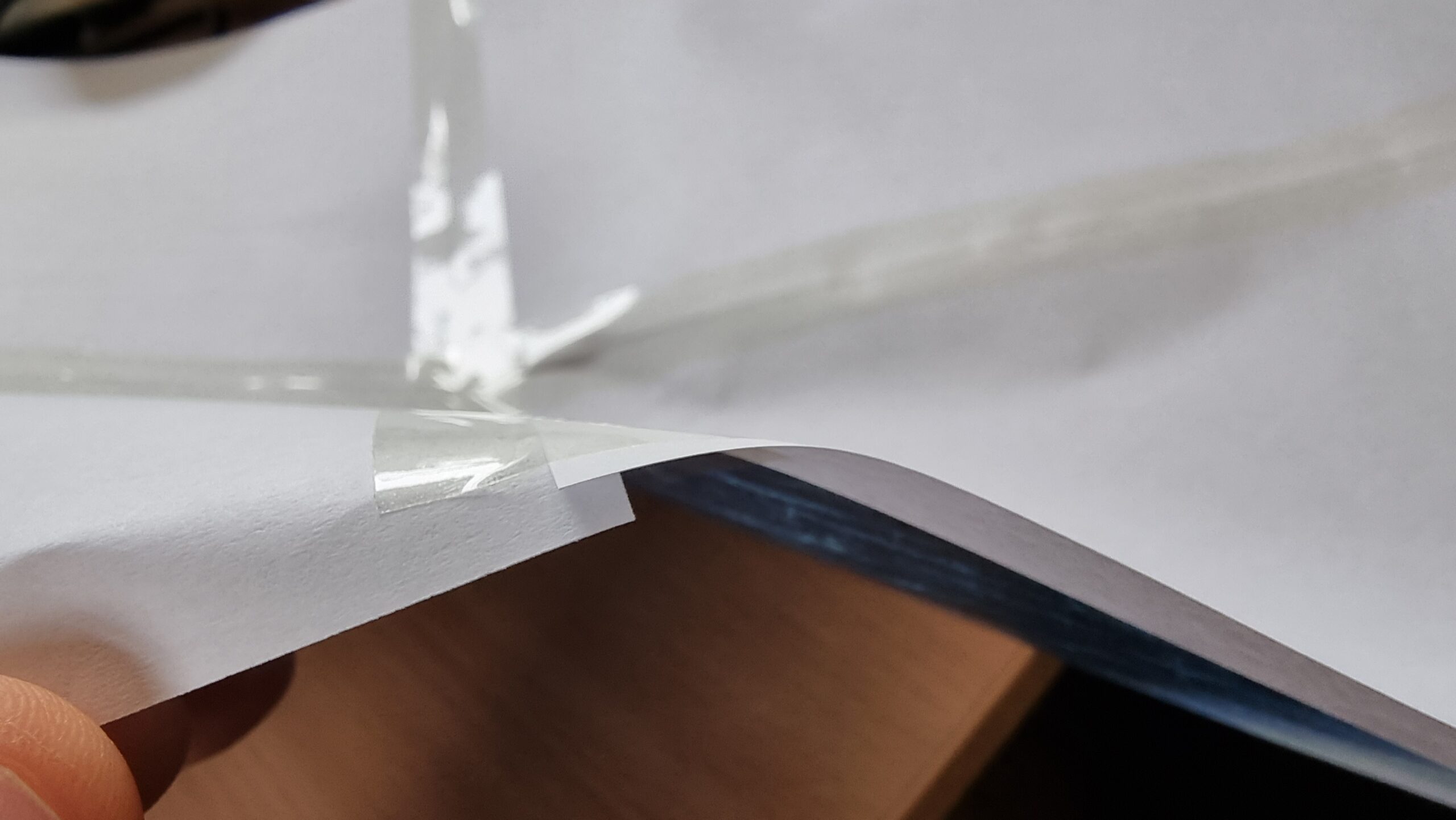 Full image of Multiple sheets of A4 paper joined with a slight overlap by long strips of sticky tape.