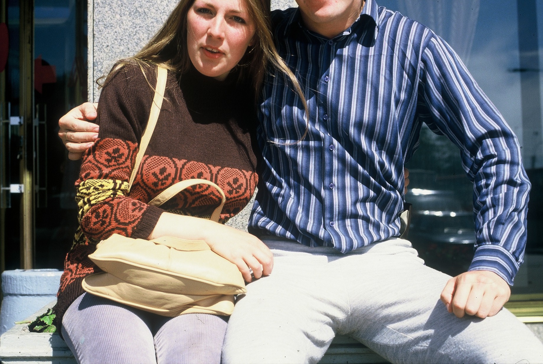 Full image of Dan's mum and dad, with the top halves of their heads cut-off by the poor framing of the picture.