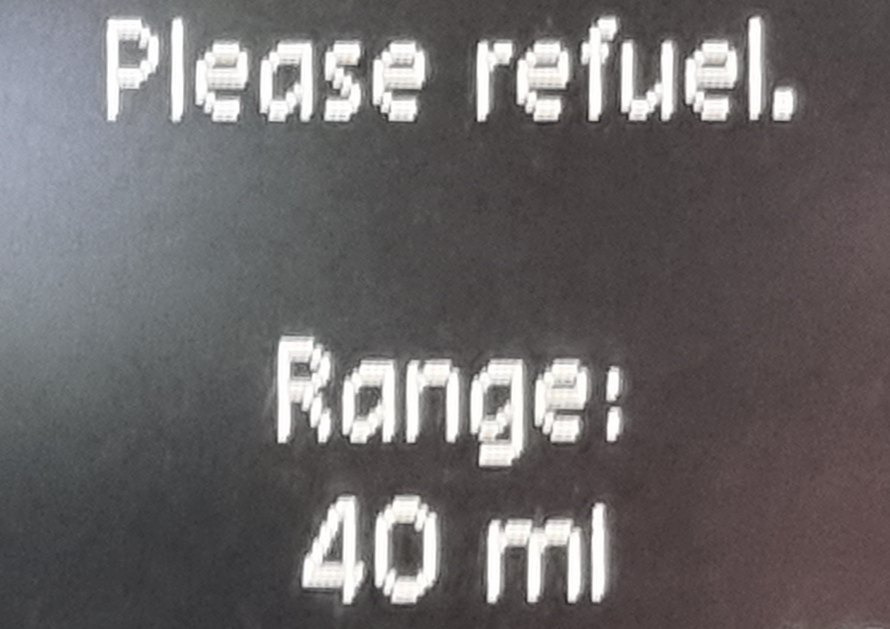 Full image of Car display showing "Please refuel. Range: 40ml"