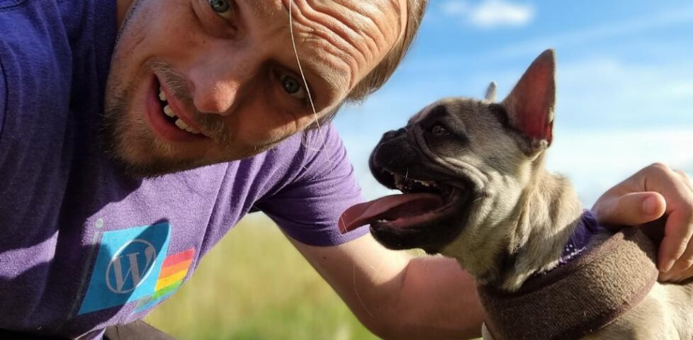 Dan with Demmy, the dog, on a footpath in a long cornfield.