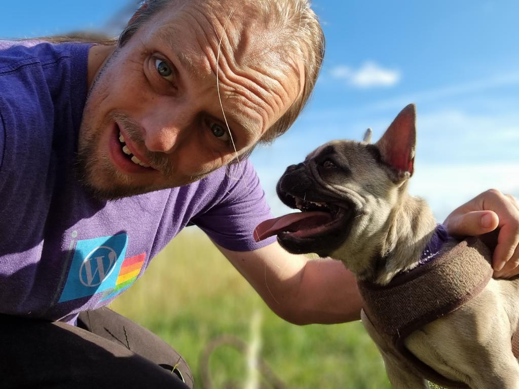 Dan with Demmy, the dog, on a footpath in a long cornfield.