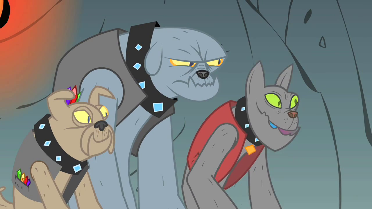 Full image of The Diamond Dogs, from My Little Pony: Friendship is Magic season 1, episode 19. A cartoon image shows three humanoid doglike creatures with gem-encrusted collars and gemstones in their pockets. They're facing off-screen, to the right.