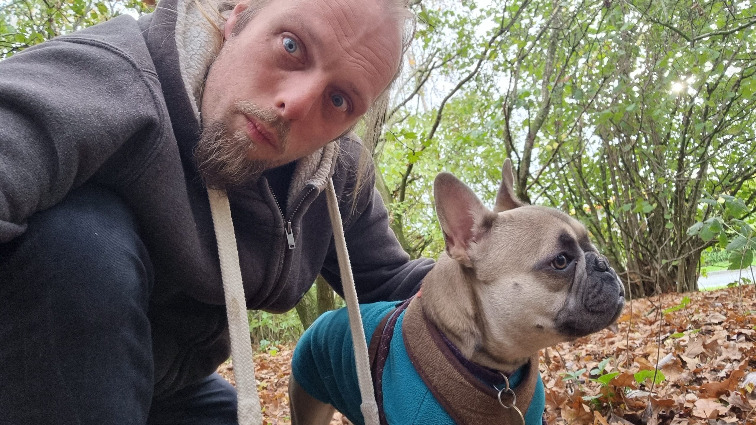 Full image of Dan and Demmy in a lightly-wooded area.