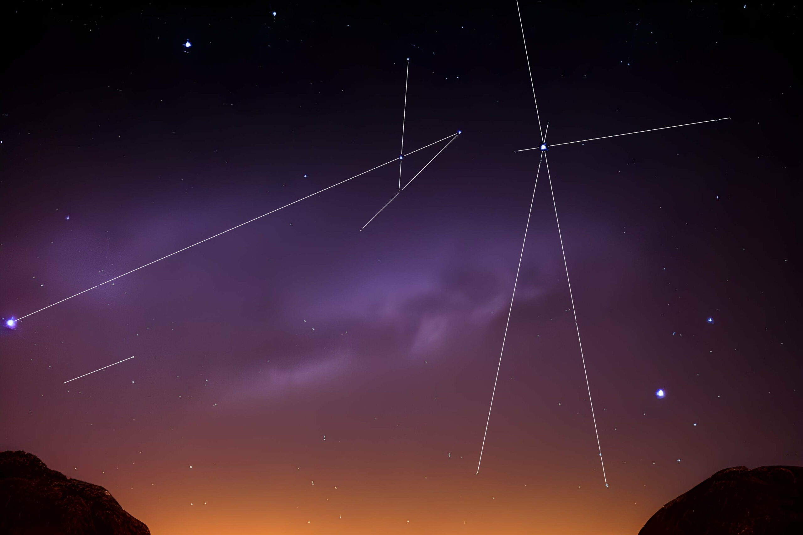 Full image of Two abstract constellations of stars drawn onto a picture of stars over the hills as the last of the sunlight begins to vanish.
