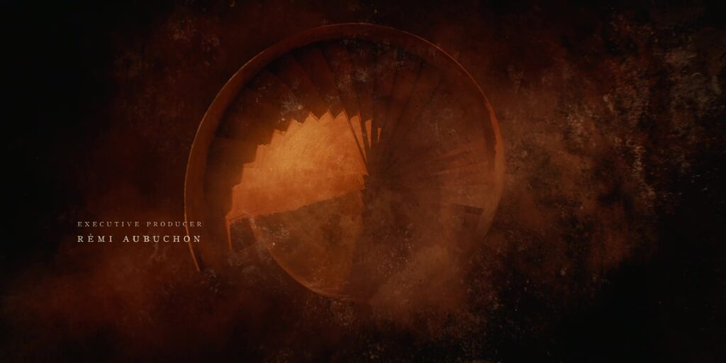 A cog crossfades into a top-down view of a spiral staircase.