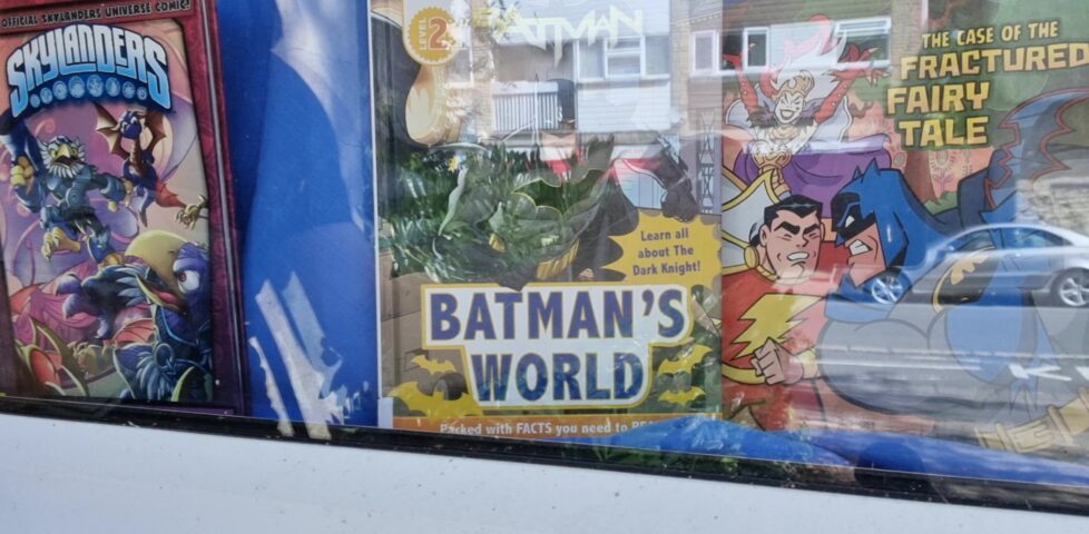 "Batman's World" comic book in the window of a public library