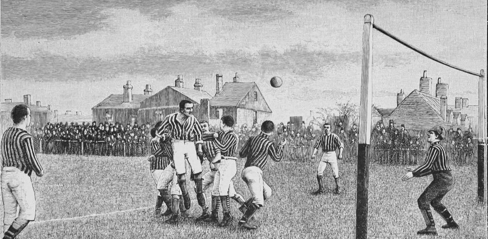 Monochrome line drawing showing a 19th century scene of a football match. The ball appears to have been headed towards the goal by a jumping player; the goalkeeper is poised to dive for it.