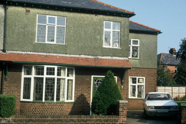 A partially-pebbledashed house.