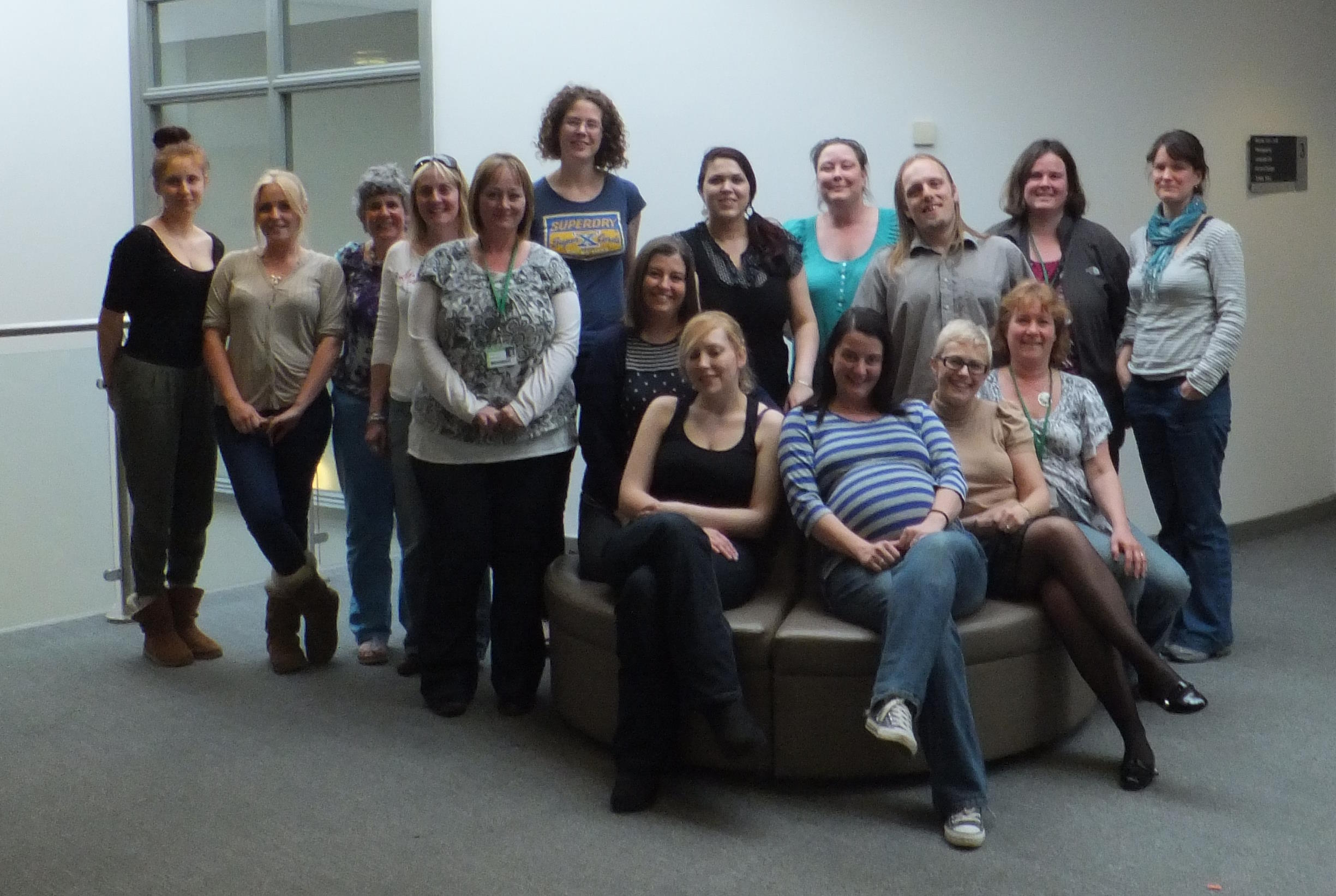 Full image of A group of 16 counselling students outside a classroom: all are white, and with the exception of Dan, all are women.