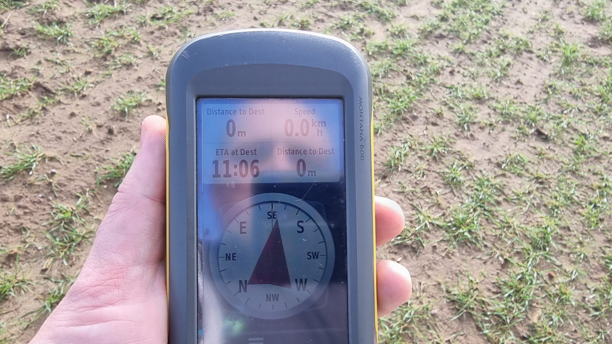 Full image of GPSr showing 0 metres to destination. A reflection of Dan's face can be seen in its screen.