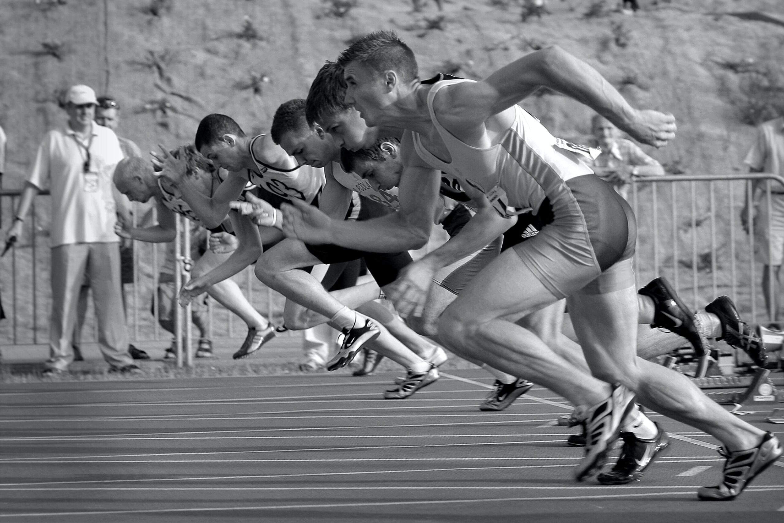 Full image of Monochrome photograph showing sprinters at the starting line.