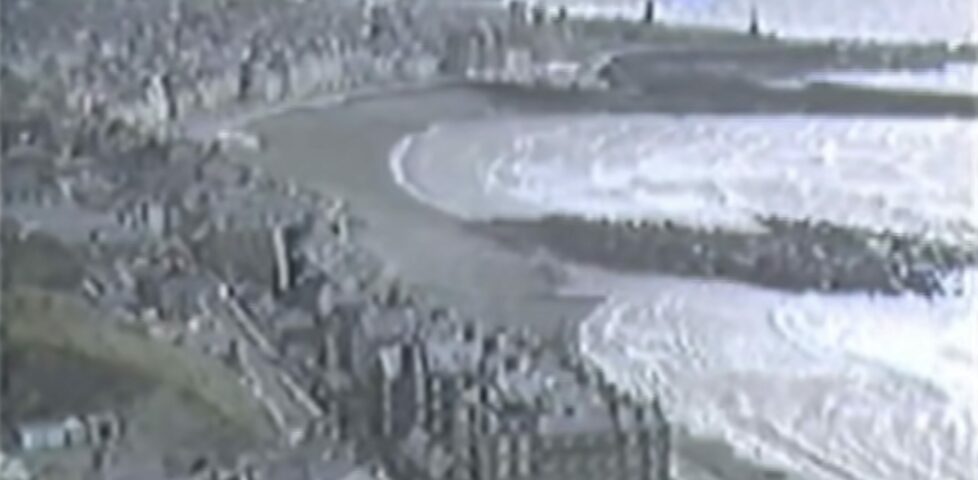 VHS-quality screeengrab showing Aberystwyth circa 1984, curving around the bay, as seen from Constitution Hill.