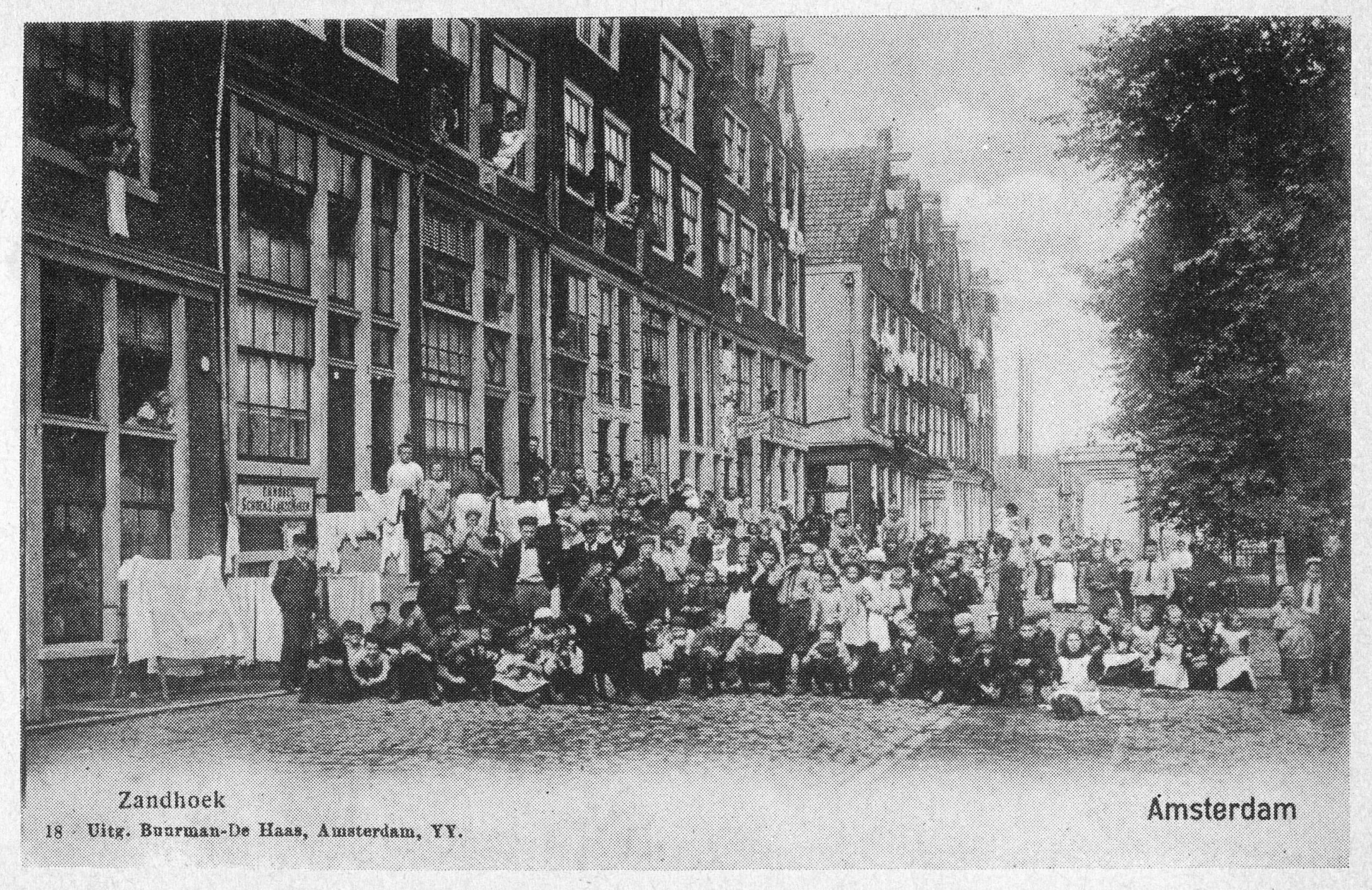 Full image of Pre-WWI Neighbourhood gathering in Amsterdam, with enormous windows (especially on the ground floor) visible.