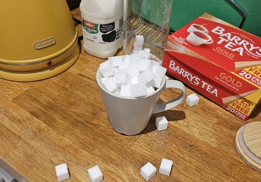 A mug overflows with sugar cubes in A Proper Cup Of Tea.
