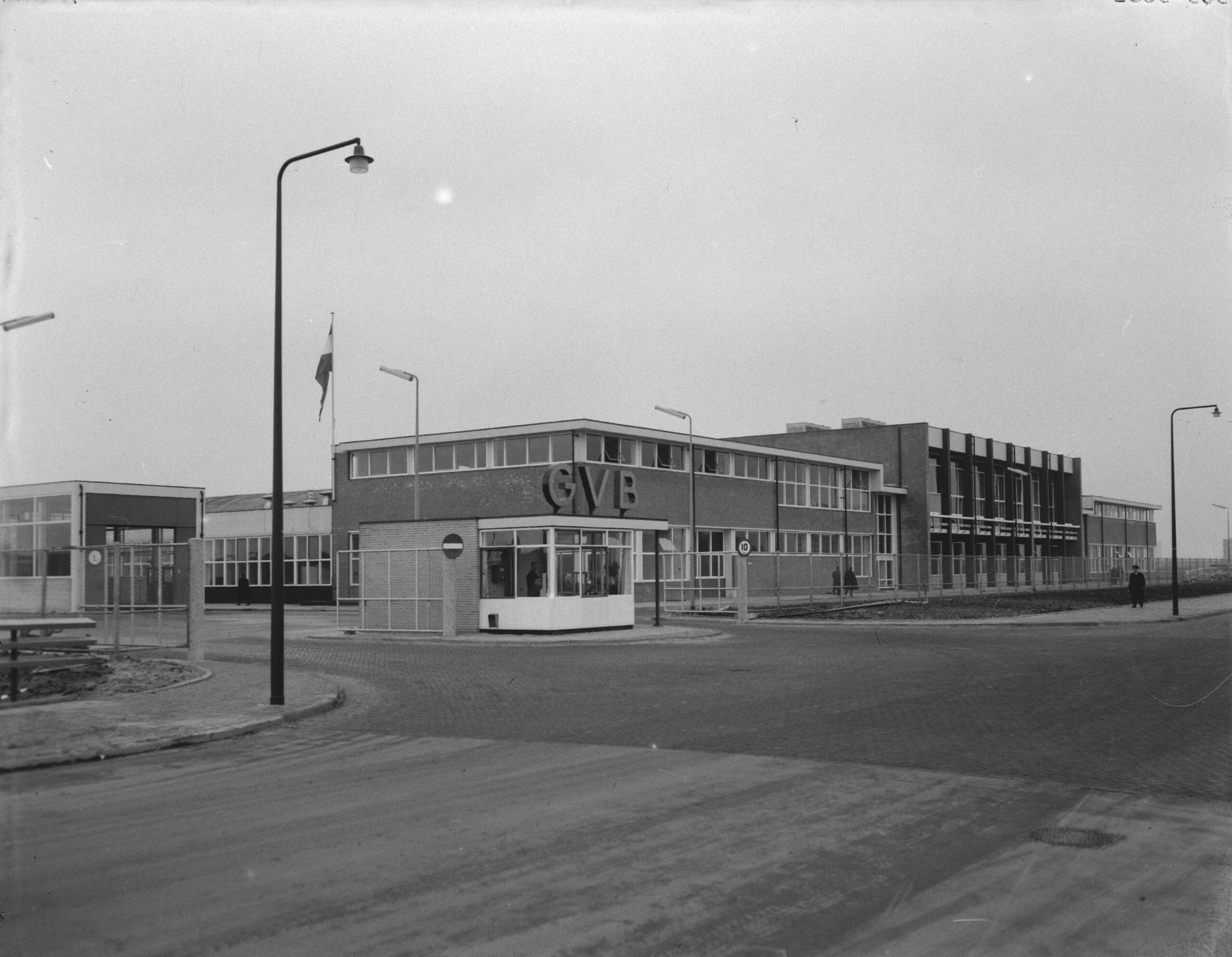 Full image of 1950s black and white photo showing a newly-opened "GVB" bus depot in West Amsterdam.