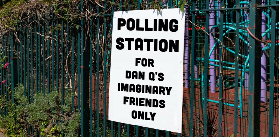 Sign on the fence of a school playground reading, in block capitals: "Polling station for Dan Q's imaginary friends only".