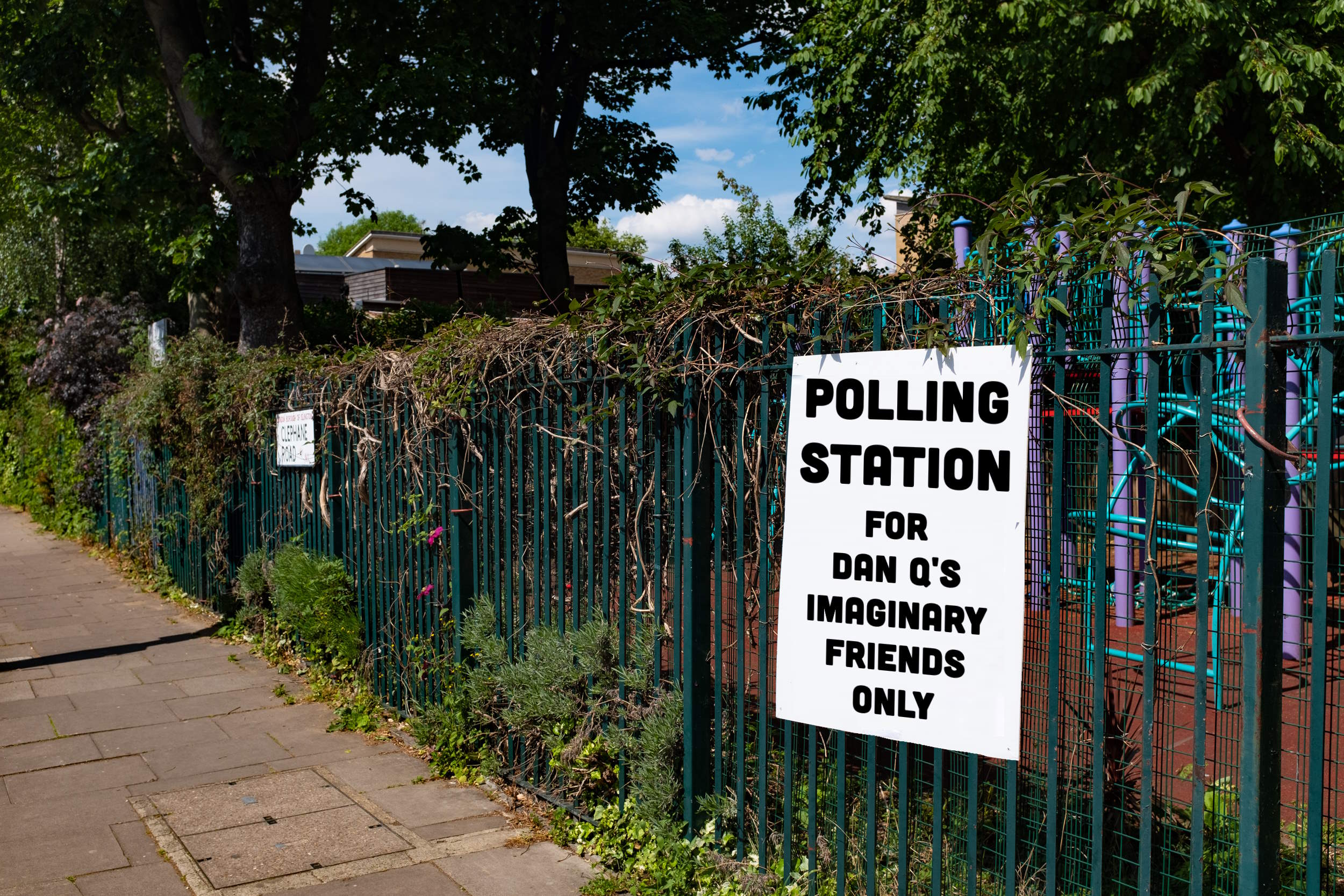 Full image of Sign on the fence of a school playground reading, in block capitals: "Polling station for Dan Q's imaginary friends only".