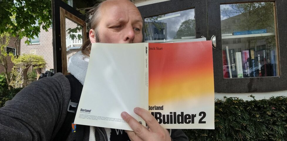 Dan squints into a copy of a book, Borland JBuilder 2 Quick Start.