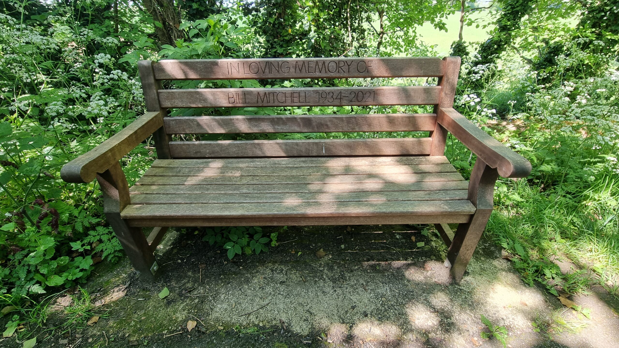 Full image of Memorial bench with inscription "In loving memory of Bill Mitchell 1934-2021"