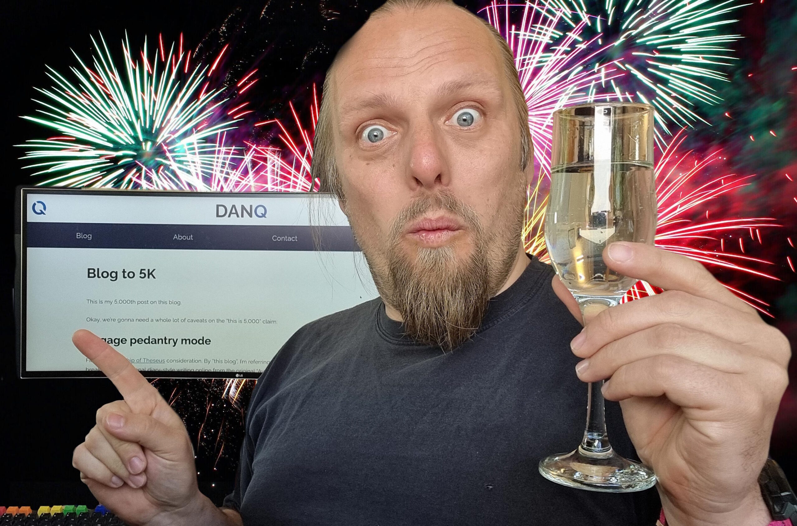 Full image of Dan with a champagne flute, fireworks in the background, points to a screen showing this blog post.