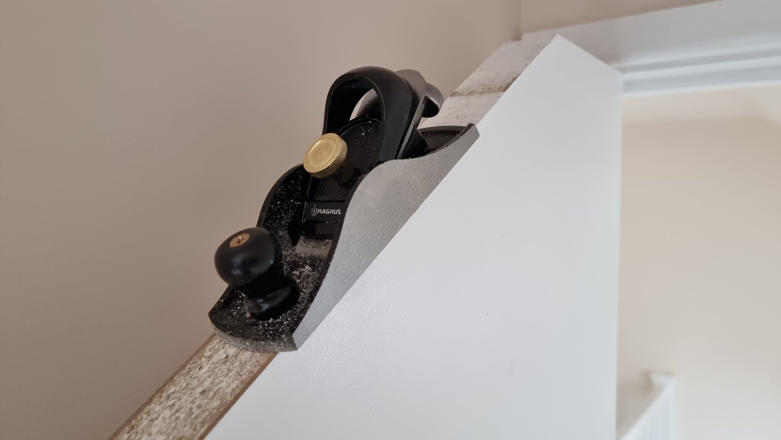 Full image of A small box plane perched atop a sloping door.