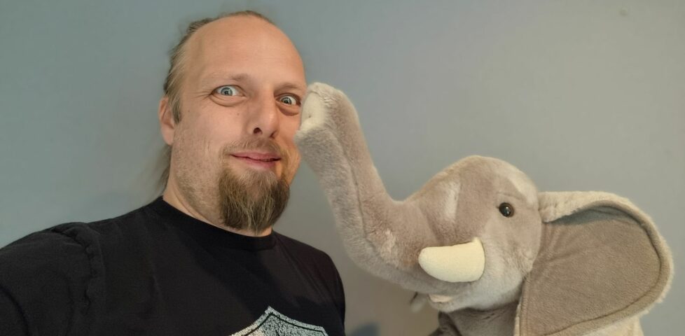 Dan with a stuffed toy (African) elephant.
